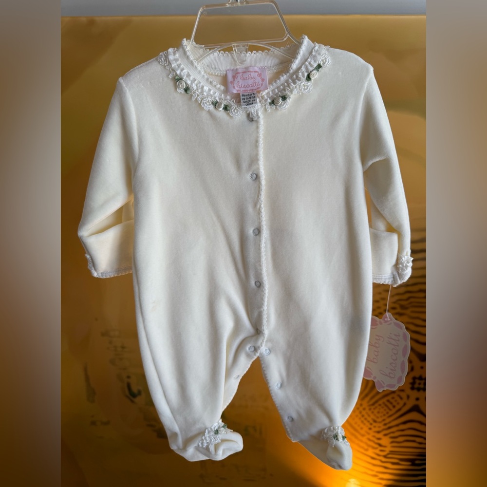 Beautiful baby fleece onesie with satin flowers.